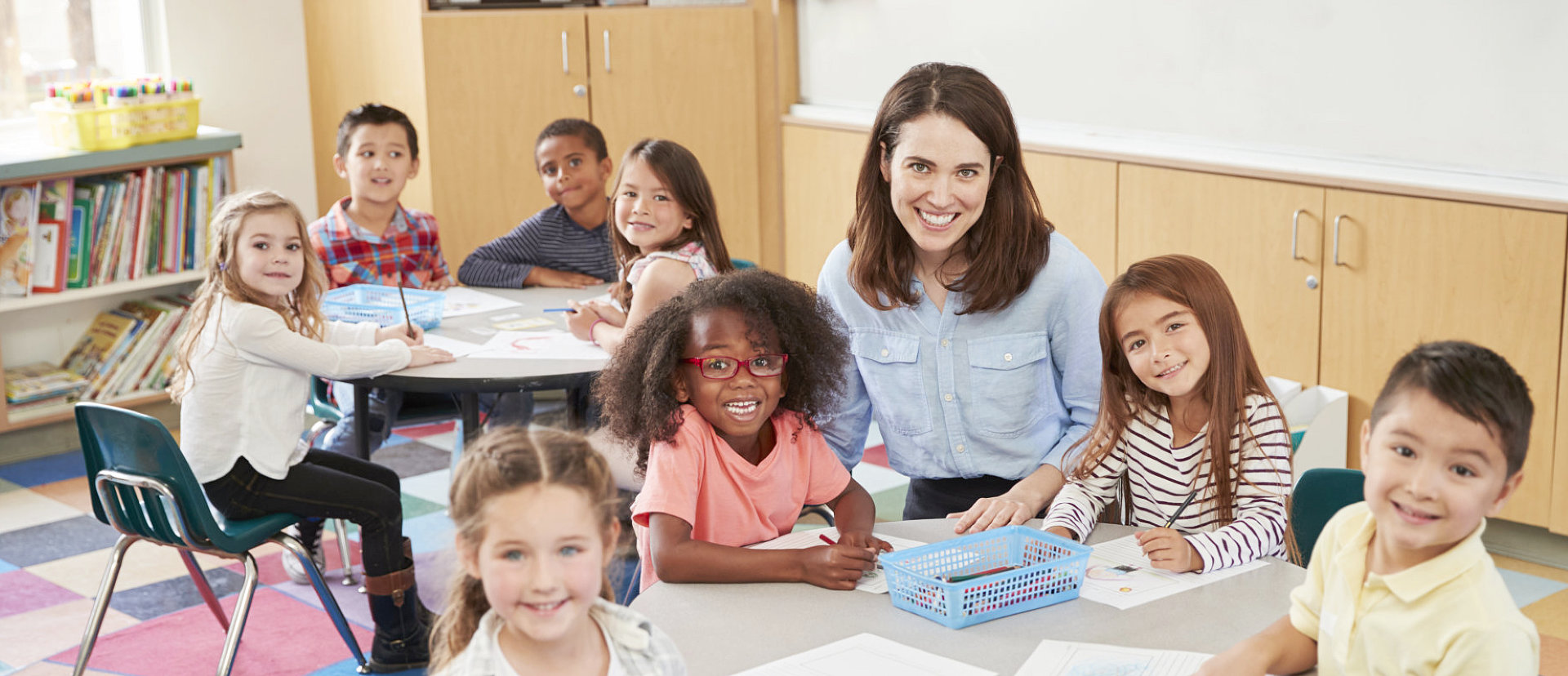 children and teacher smiling